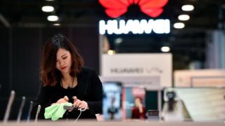 Woman polishes Huawei phone