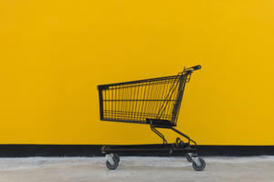 Shopping cart against yellow building